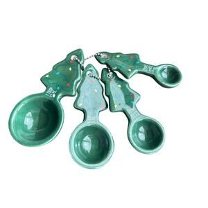 Set of four ceramic measuring spoons shaped like Christmas trees baking